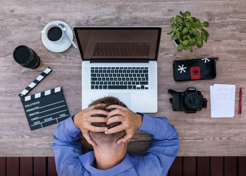 frustrated person in front of a laptop