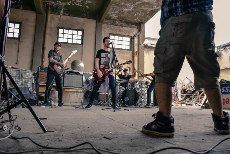 rock band practicing in an old warehouse