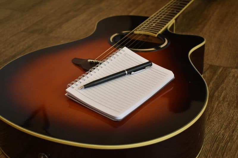 acoustic guitar with a notebook
