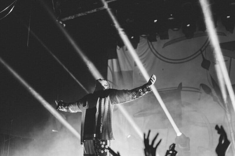 vocalist performing on stage in front of a big crowd