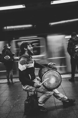 drummer performing in a train station