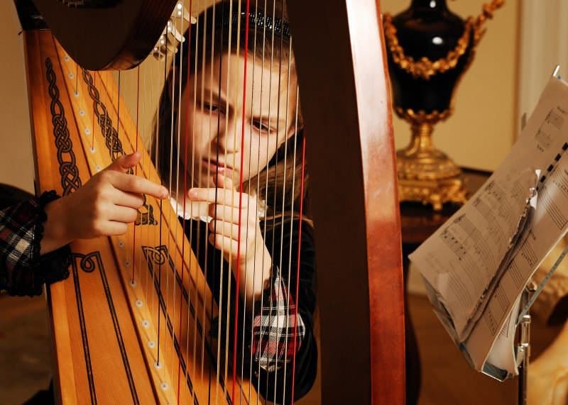 kid playing a harp