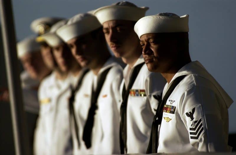 a group of naval officers, symbolizing the teamwork of being in a band