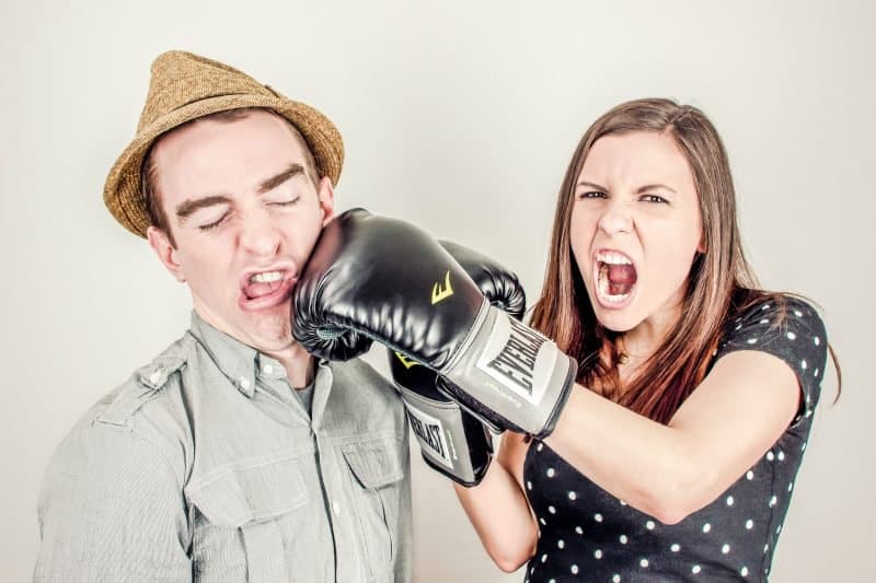 people boxing to symbolize people fighting over mixing with headphones