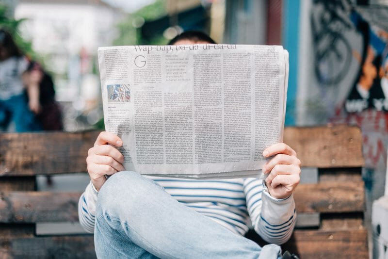 person looking at a newspaper