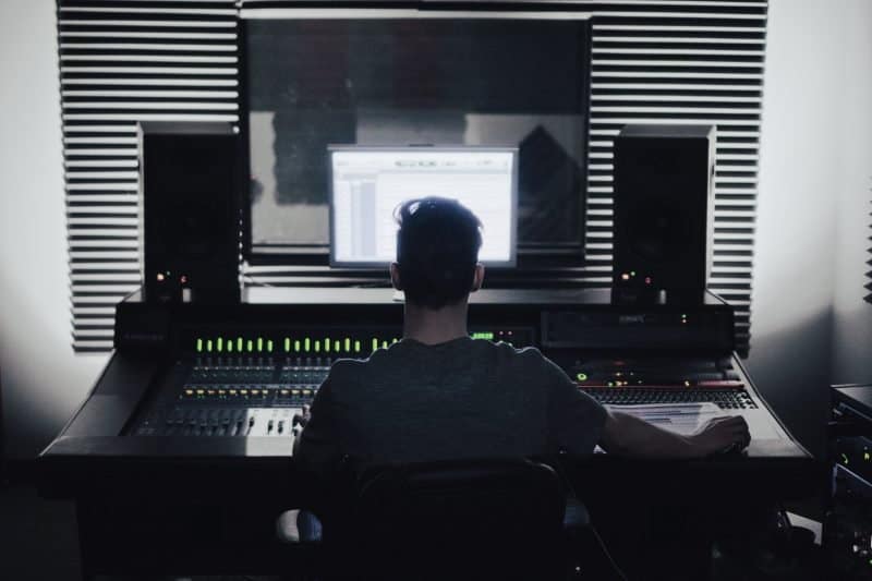 mixing engineer sitting at a mixing desk