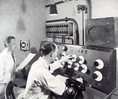 early 1900s audio engineers working on vintage gear