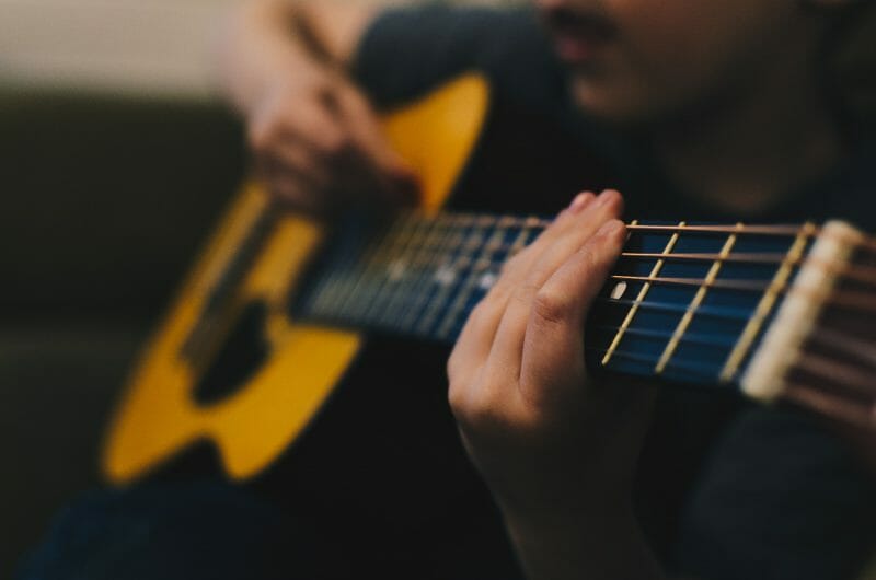 person playing an acoustic guitar