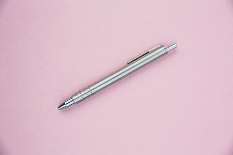fancy silver pen on pink background