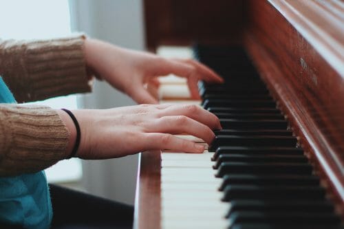 person playing a borrowed chord on a piano