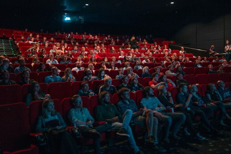 people sitting in a theater watching a film that could include your licensed music