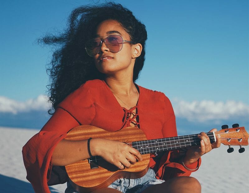 musician playing ukulele outside