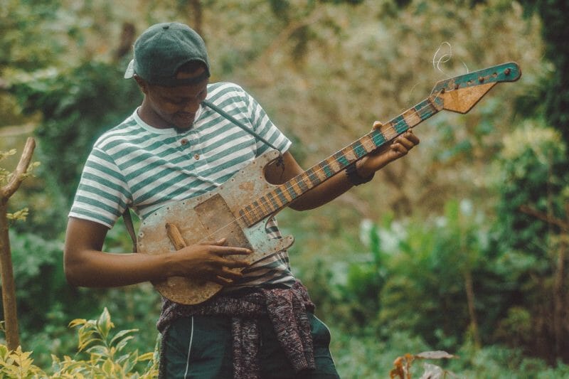 guitarist playing a one stringed guitar