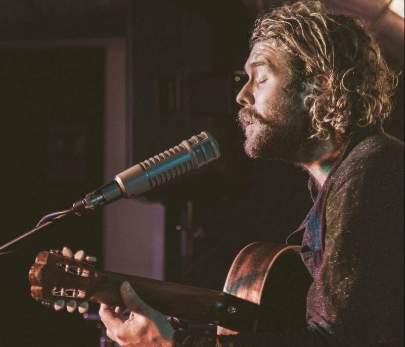 singer songwriter playing guitar