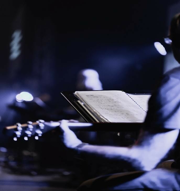 guitarist playing sheet music