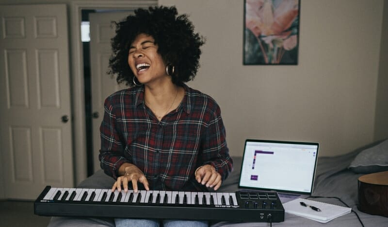 singer singing and playing piano