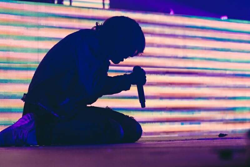 vocalist on stage holding a microphone